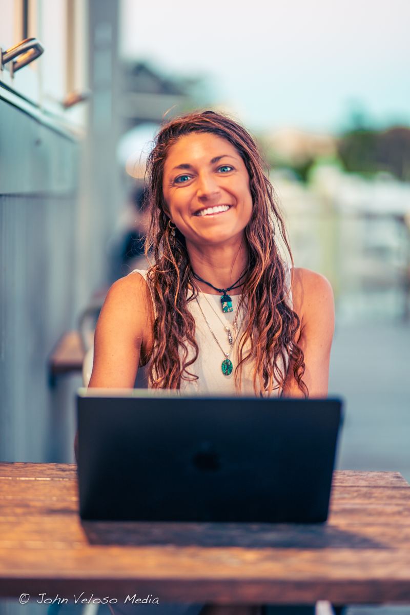 Larissa Mahony, founder of ABC Digital Marketing, smiling at her laptop